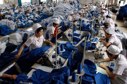 Employees work at a production line of a garment factory in Huaibei